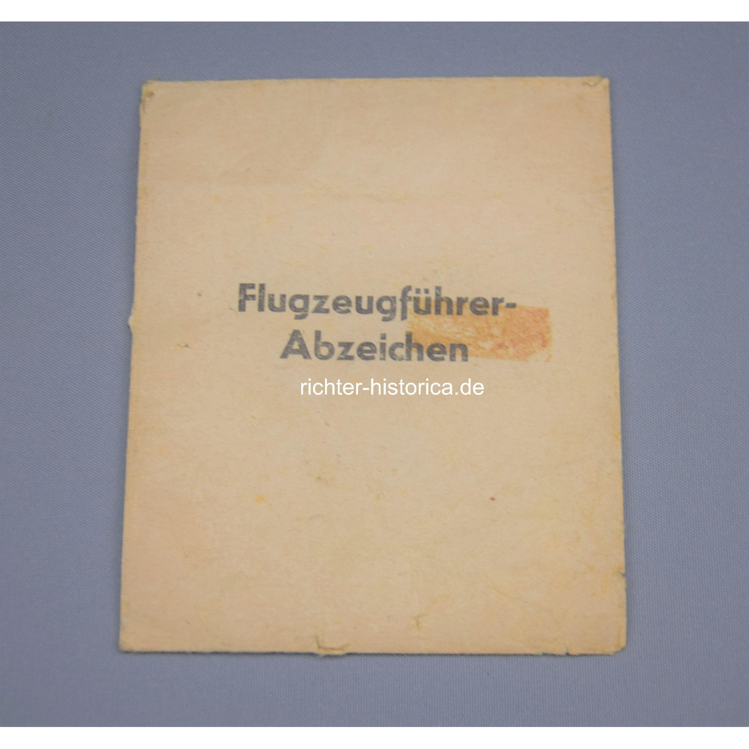 Flugzeugführer Abzeichen in Wickelpapier und Verleihungstüte, BSW